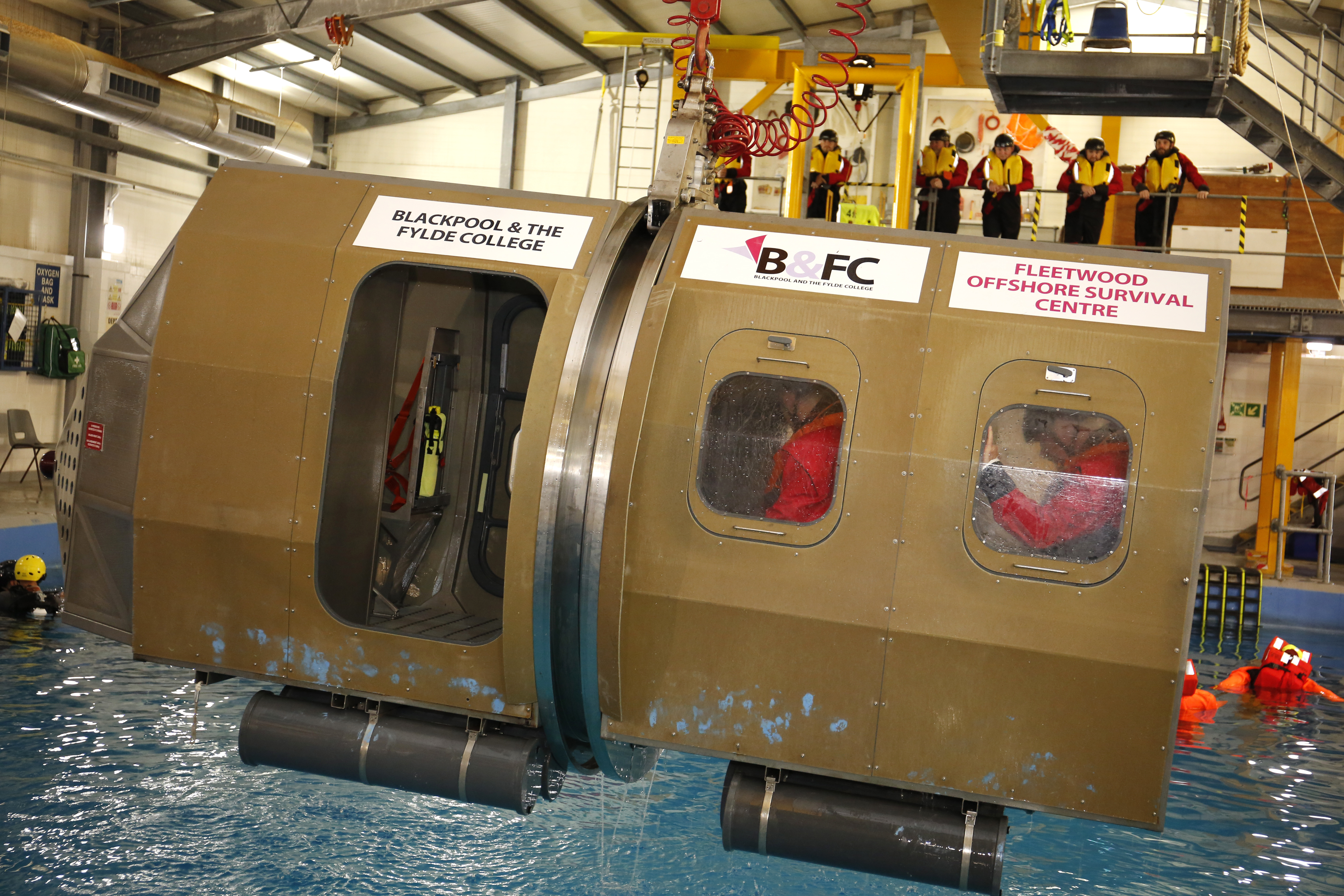 Image showing people inside underwater escape simulation pod